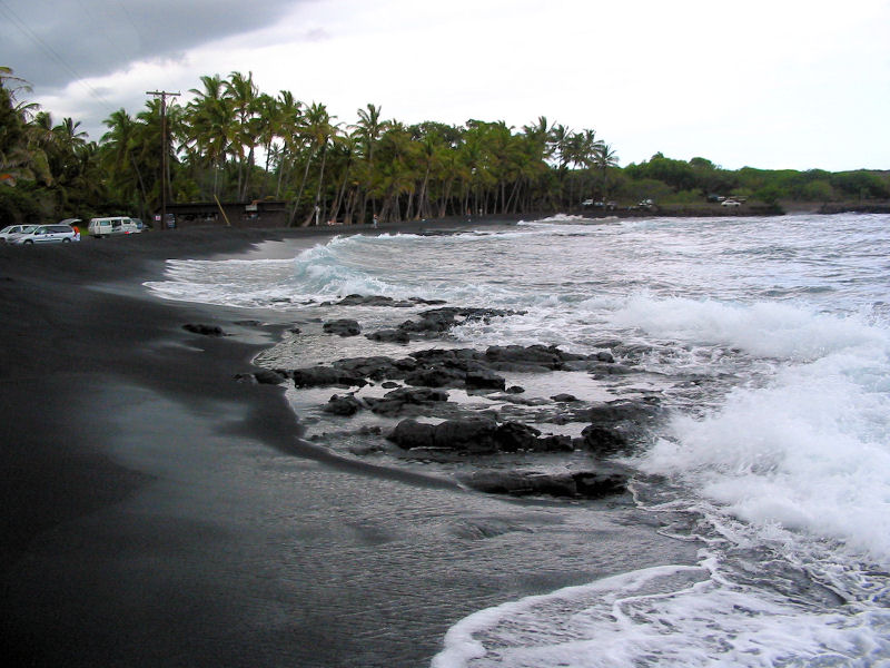 waves crashing on black sand beach