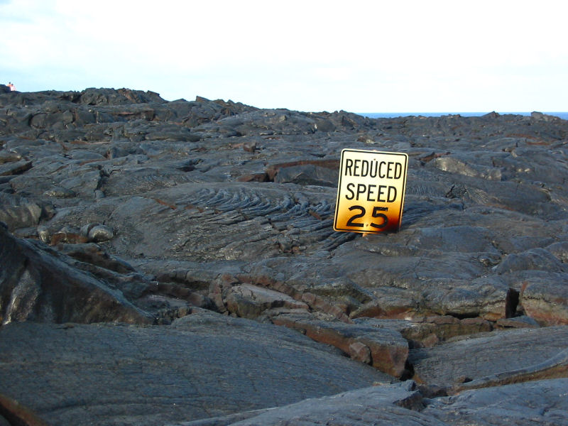 Road sign overcome by lava